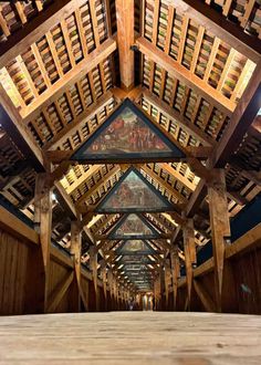 the inside of a building with wooden beams