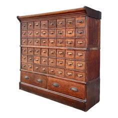 an old wooden filing cabinet with many drawers