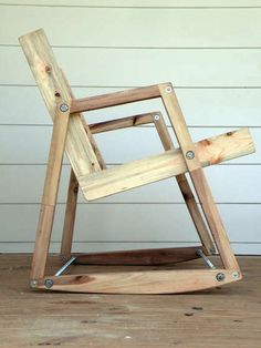 a wooden chair sitting on top of a wooden floor