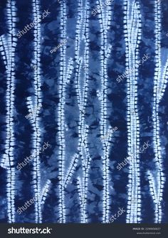 blue and white tie - dyed fabric with vertical lines in the center, all on one side