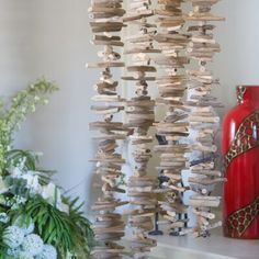 a wind chime hanging from the ceiling next to a vase