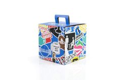 a suitcase with stickers all over it sitting on a white surface in front of a white background