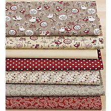 four different fabrics are stacked on top of each other, one is red and the other has