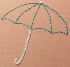 an umbrella made out of string and beads on a pink background with the word love written in it