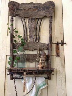 an old wooden chair hanging on the wall