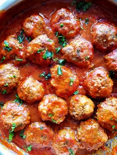 meatballs and sauce in a pan with parsley on the top, ready to be eaten