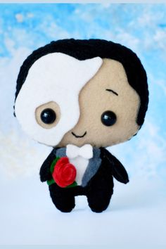 a small stuffed animal with a red rose in its hand