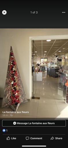 an image of a christmas tree in the middle of a room with other items on display