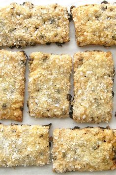 several squares of food sitting on top of a white surface