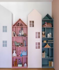 a doll house built into the side of a bookcase in a child's room