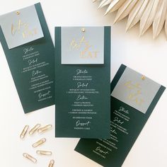 three green and silver wedding cards with gold foil lettering on the front, back and sides