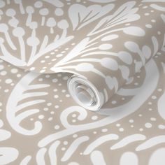 a white and beige wallpaper with an intricate design on it's surface,