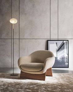 a chair and lamp in a room with concrete walls, flooring and rugs