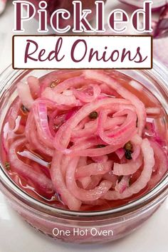 pickled red onions in a glass bowl with the title overlay reads pickled red onions