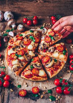 a pizza with mushrooms, tomatoes and other toppings