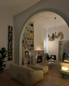 a living room filled with furniture and a fire place in the middle of a room