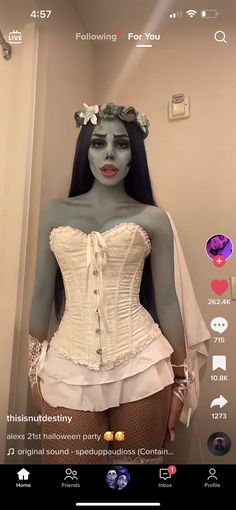 a mannequin dressed as a woman with makeup on her face and hair in the shape of a corset