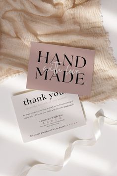 a thank you card sitting on top of a white sheet with the words hand made