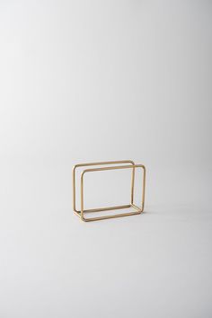 a gold square ring on a white background