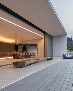 a wooden bench sitting on top of a hard wood floor next to a large window