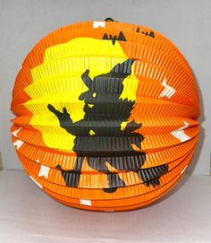 an orange paper plate with black designs on it