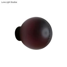 an image of a black ball on a white background with the words luna light studios written below it