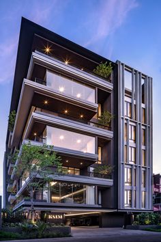 an apartment building with many balconies and plants on the balconys at night