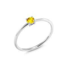 a white gold ring with a yellow sapphire stone