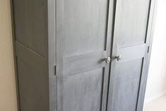 an armoire in the corner of a room