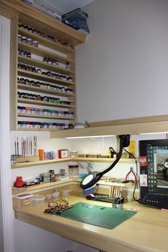 a computer monitor sitting on top of a wooden desk