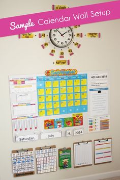 a wall calendar is hanging on the wall next to a bulletin board with magnets