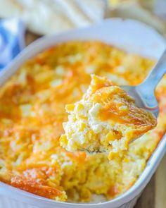 a spoonful of cheesy hash browns casserole in a white dish