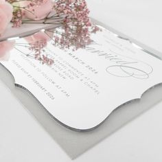 a close up of a wedding card with flowers on it