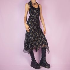 The Y2K Black Lace Asymmetrical Midi Dress is a vintage 2000s piece featuring a halter neck design and intricate golden floral lace detailing over a delicate mesh fabric. The dress is accented with ruffles along the neckline, adding a touch of romance and elegance. Perfect for a night out or special occasion. SIZE XS MEASUREMENTS Chest 72cm - 28.34 inch Waist 64cm - 25.19 inch Our model is 172 cm tall and usually wears size XS. We ship worldwide from Spain and offer free shipping on all orders w Asymmetrical Midi Dress, Dress Halter, Y2k Black, Mesh Dress, Dress Clothes For Women, Neck Designs, Lace Detail, Floral Lace, Vintage Y2k