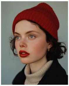 a woman wearing a red hat and sweater