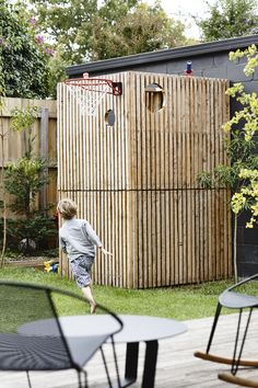 a young boy playing basketball in his backyard