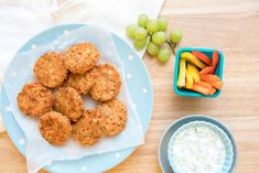 a blue plate topped with meat patties next to a bowl of ranch dressing