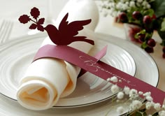 a place setting with napkins and flowers