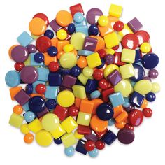 many different colored candies on a white surface