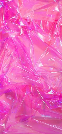 pink plastic bags are piled on top of each other