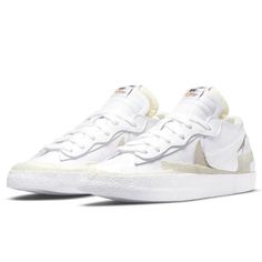 The Sacai X Nike Blazer Low ‘White Patent’ Reimagines The Vintage Silhouette With Designer Chitose Abe’s Deconstructed Aesthetic. The Upper Is Crafted From Glossy White Patent Leather With An Exposed-Foam Collar And A Pair Of Overlapping Swooshes, One In Grey Suede, The Other In White Matte Leather. Eyestays And Tongues Are Similarly Doubled Up, While Multiple Layers Of Textured Rubber Reinforce The Toe, Midfoot And Heel. Dual Nike And Sacai Branding Decorates The Sockliner. Underfoot, A Traditi White Leather High-top Sneakers With Rubber Waffle Outsoles, White Low-top Basketball Shoes With Contrast Sole, White Sneakers With Rubber Sole And Medium Fit, Summit White Round Toe Sneakers For Streetwear, White High-top Sneakers With Rubber Waffle Outsoles For Sports, Summit White Sneakers For Streetwear With Round Toe, White Sporty Custom Sneakers With Gum Sole, Summit White Sneakers For Streetwear, White Leather Sneakers With Boost Midsole