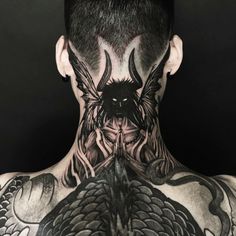 the back of a man's head with tattoos on his neck and chest,