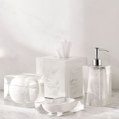 white marble bathroom accessories including soap dispenser and soap dish