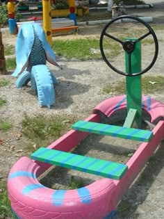 a pink and blue toy car sitting on top of a playground