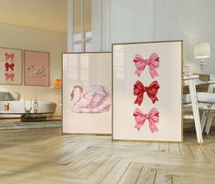 three framed pictures with pink bows and swans on them in a white living room setting