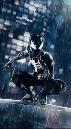 a black and white spider man statue sitting in the rain