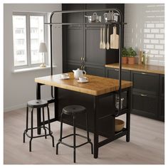 a kitchen island with two stools next to it