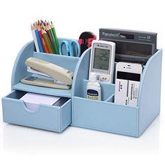 a blue desk organizer with pens, pencils, and other office supplies in it