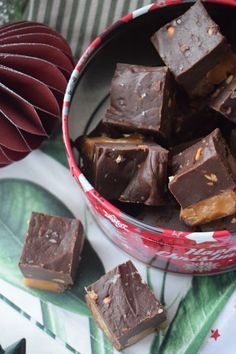 a bowl full of chocolate fudges on top of a green and white table cloth