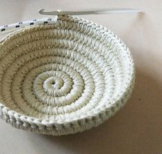 a small white basket sitting on top of a table